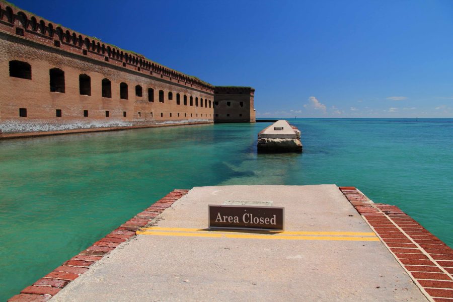 Dry Tortugas National Park, FL – September 13, 2018: A sign warns Fort Jefferson visitors to stay away from a section of moat wall damaged by Hurricane Irma